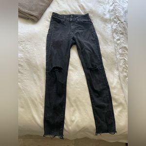 Just black faded black jeans with rip on the knee